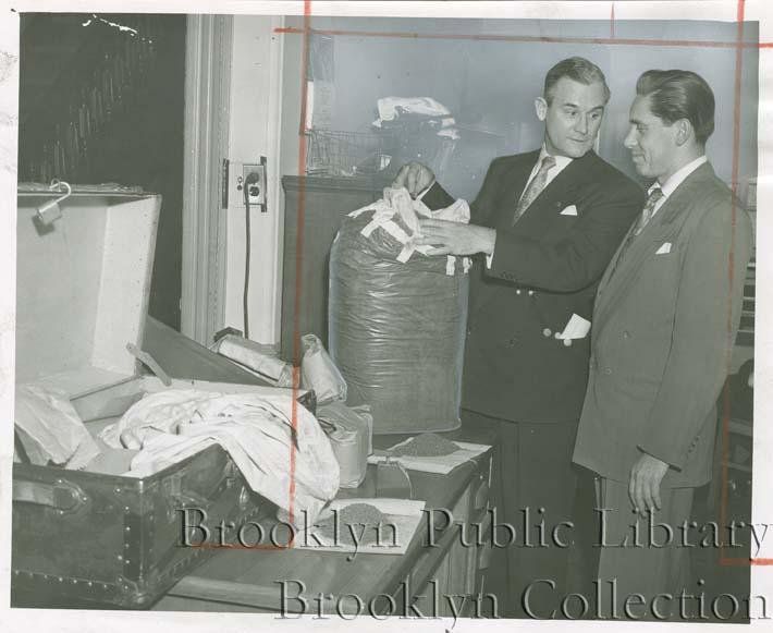 "Big marijuana haul--Seizing 80 pounds of stuff that reefers and bad dreams are made of, are Deputy Inspector Peter Terranova, head of narcotics squad, left, and Assistant D. A. Norman Felig. Cache was grabbed along with 'importer' Homer Jackson, in Bedford Stuyvesant rooming house."
